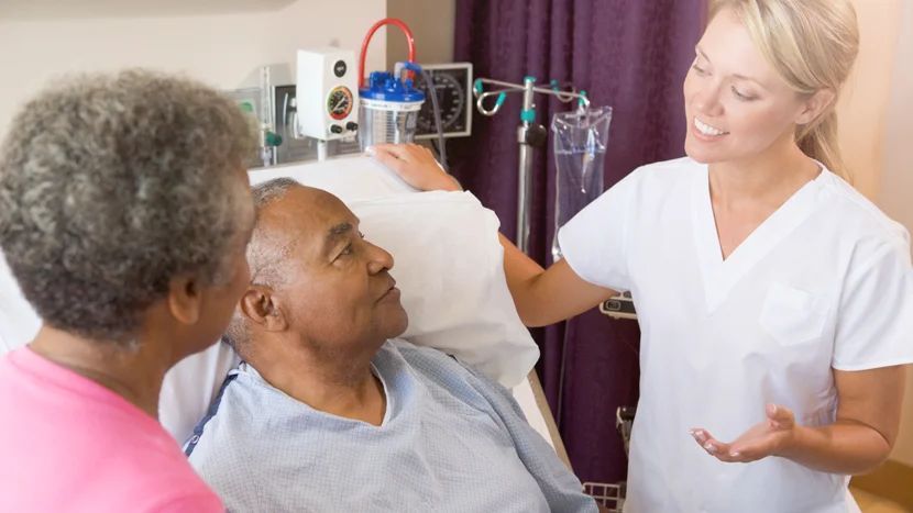 a doctor speaking to a patient and a woman