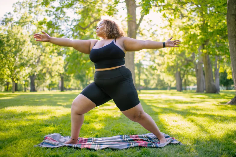 Woman performing yoga pose in the park